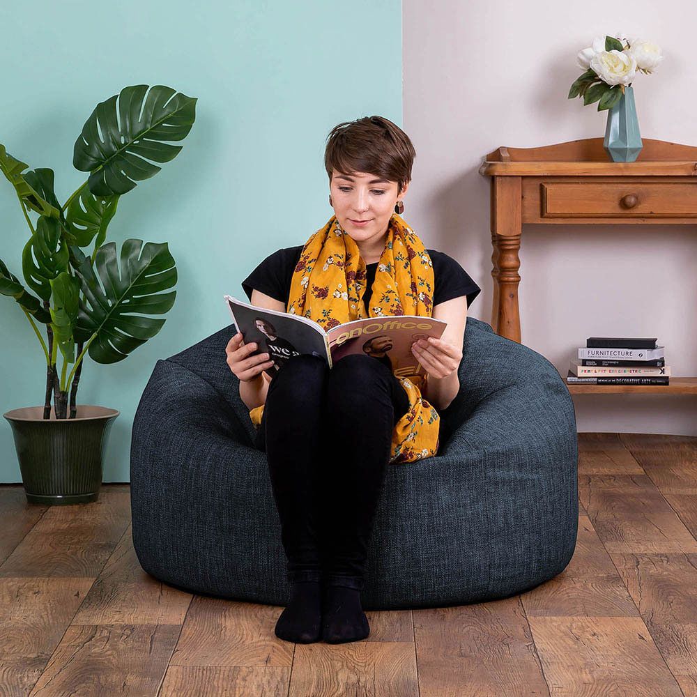 Model in icon Lina Classic Bean Bag in navy blue in living room