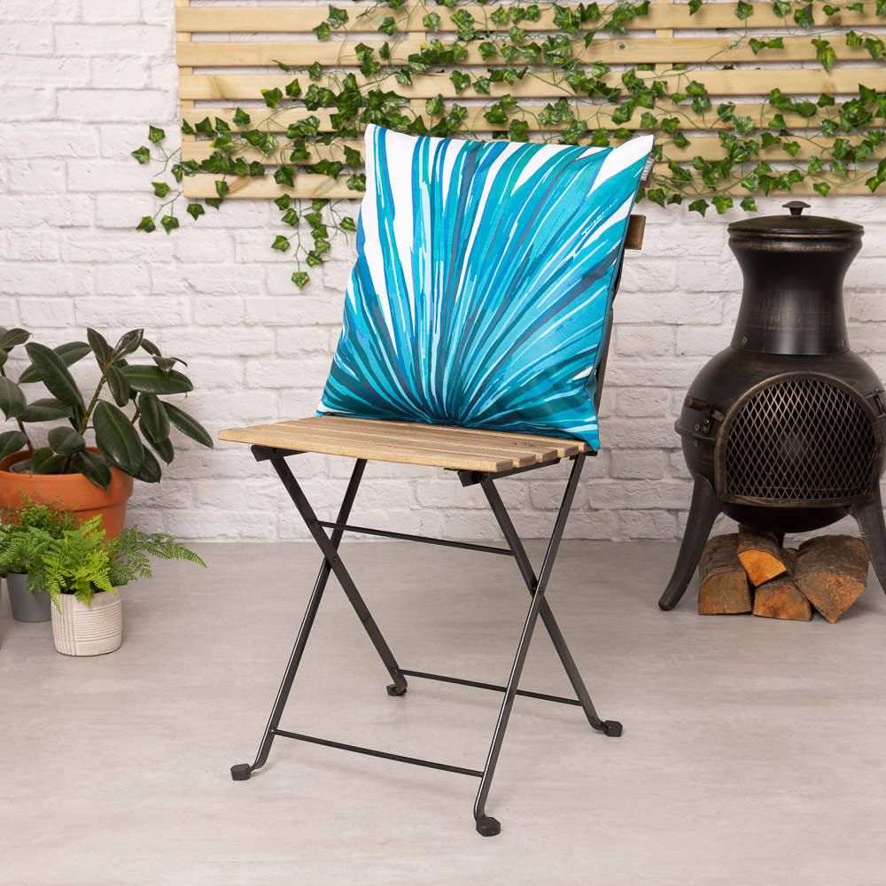 teal palm print outdoor cushion lifestyle