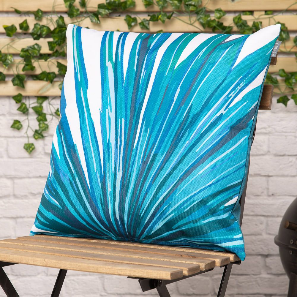 teal palm print outdoor cushion on chair