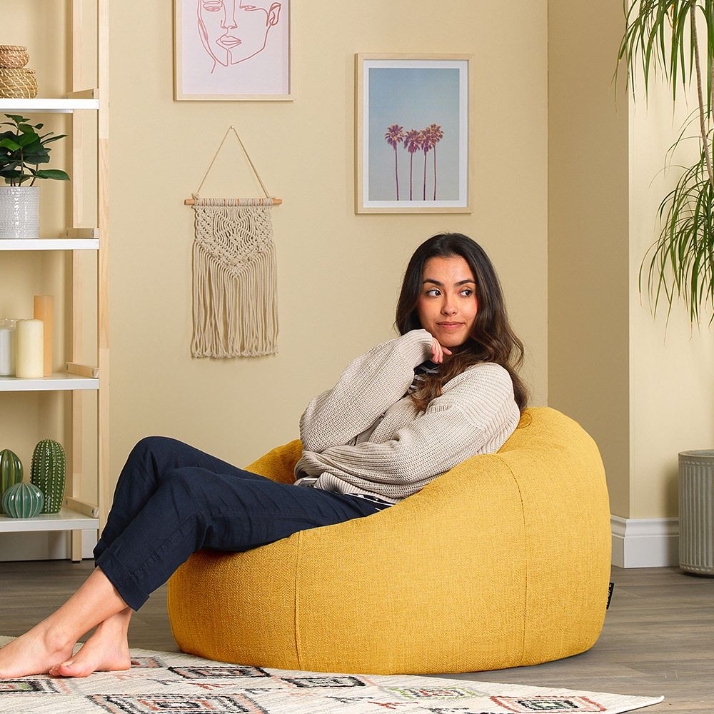 icon® Lina Classic Bean Bag in ochre with model in living room