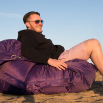 Purple Flex with boy Boy on a bean bag with shades on